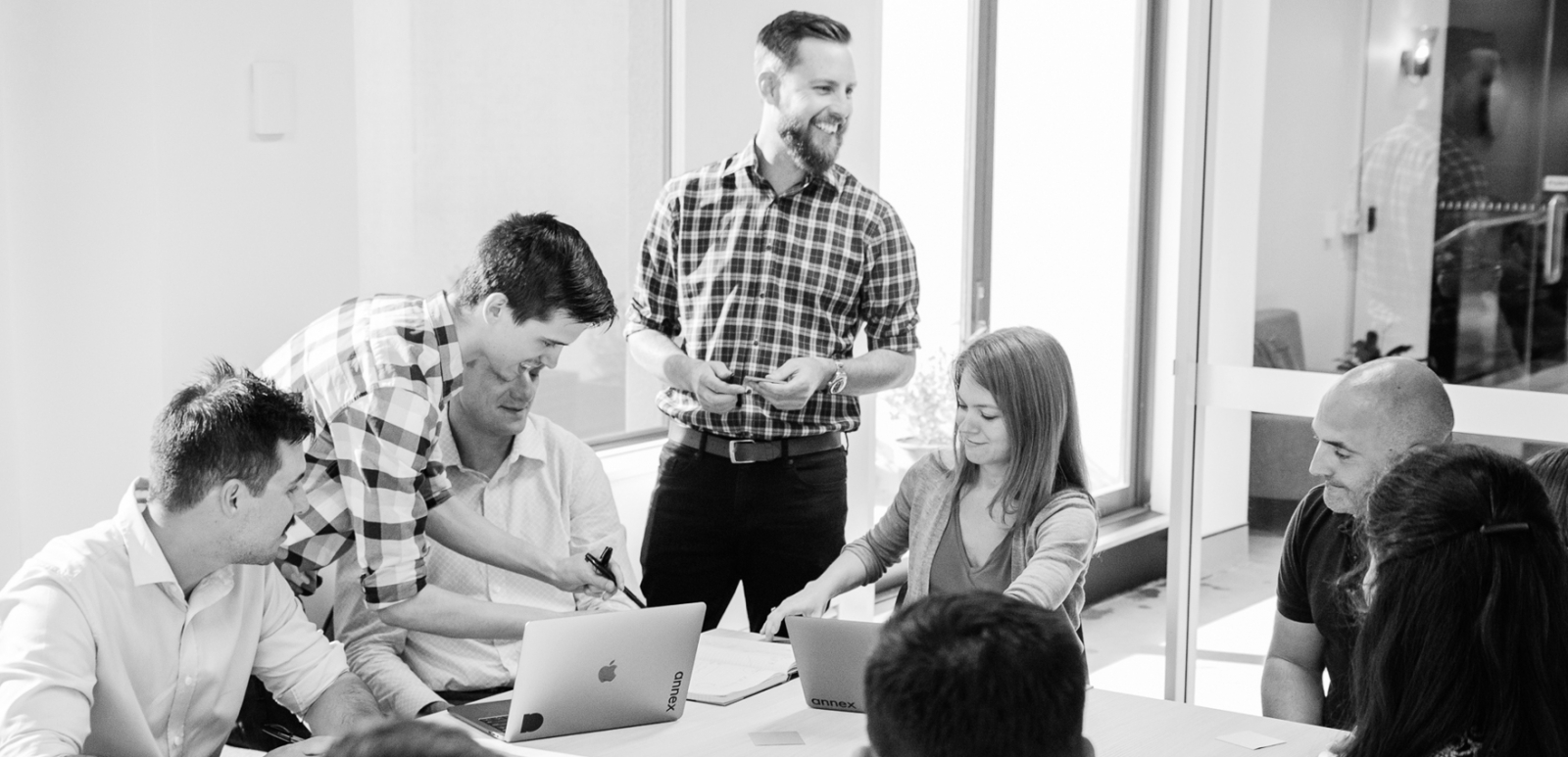 Photo of the Annex staff working together in a boardroom