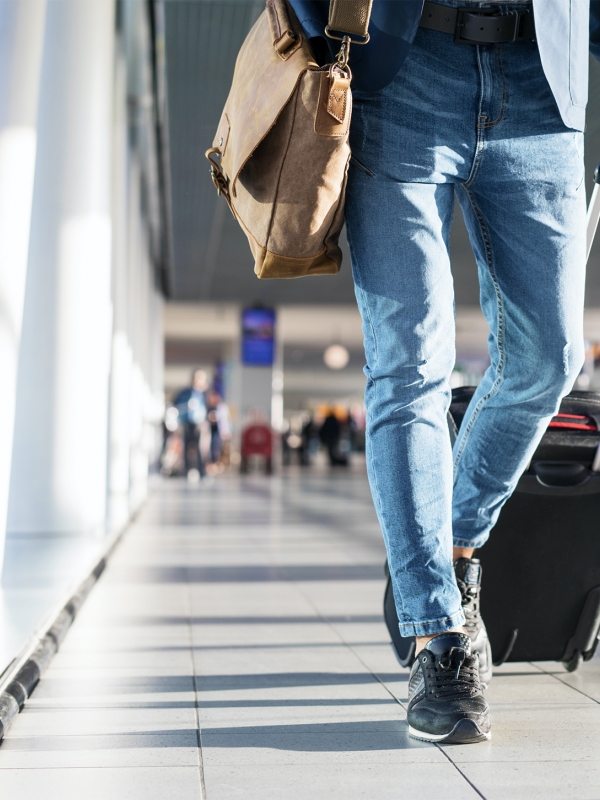 Man pulling a suitcase in an airport