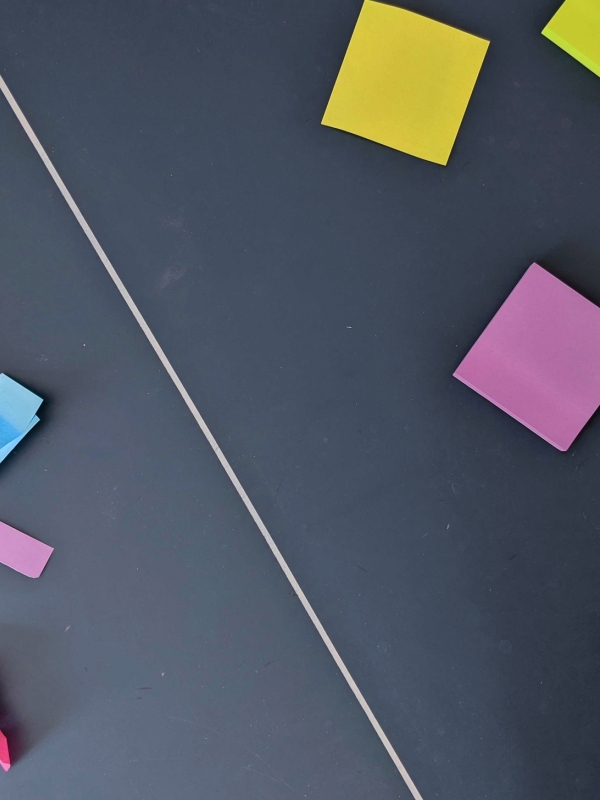 An assortment sticky notes posted on a blackboard